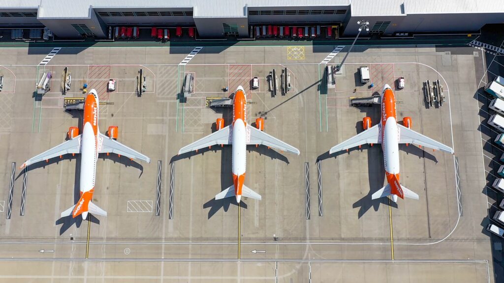 London Luton Airport from the air featuring 3 EasyJet aircraft at the terminal for boarding